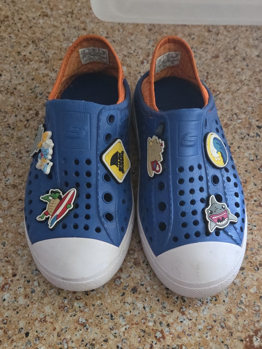 Skechers Kids Blue Slip-On Shoes with Orange Trim and Fun Charms